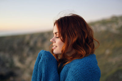 Portrait of smiling young woman looking away