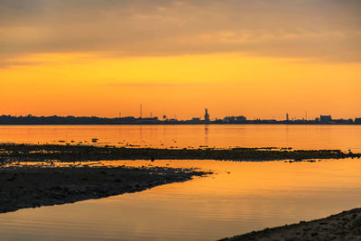 Scenic view of sea against orange sky