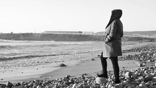 Rear view of man standing on beach