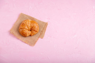 High angle view of bread on pink background