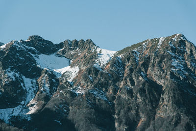 Panoramic view of snowcapped mountains against clear sky