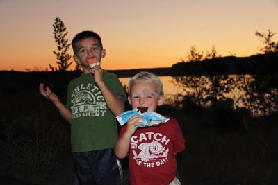 Portrait of smiling boys eating ice cream
