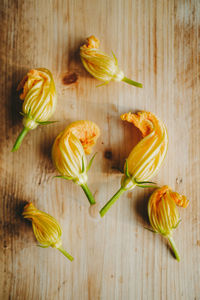 High angle view of yellow flowers on table