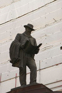 Low angle view of statue against wall