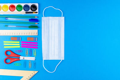 Directly above shot of colored pencils against blue background