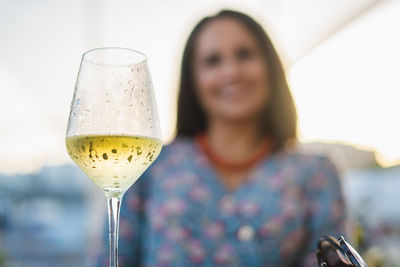 Low angle view of woman having wine in glass at restaurant