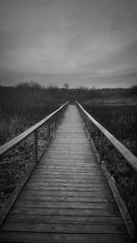 View of wooden bridge against sky