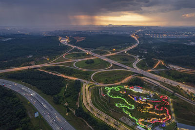 High angle view of illuminated cityscape against sky during sunset