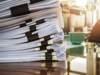 Close-up of stack of papers on table