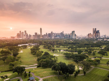 Panoramic view of buildings in city against sky during sunset