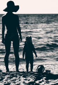 Rear view of silhouette couple on beach