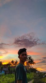 Portrait of young man against sky during sunset