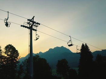 Low angle view of overhead cable car against sky