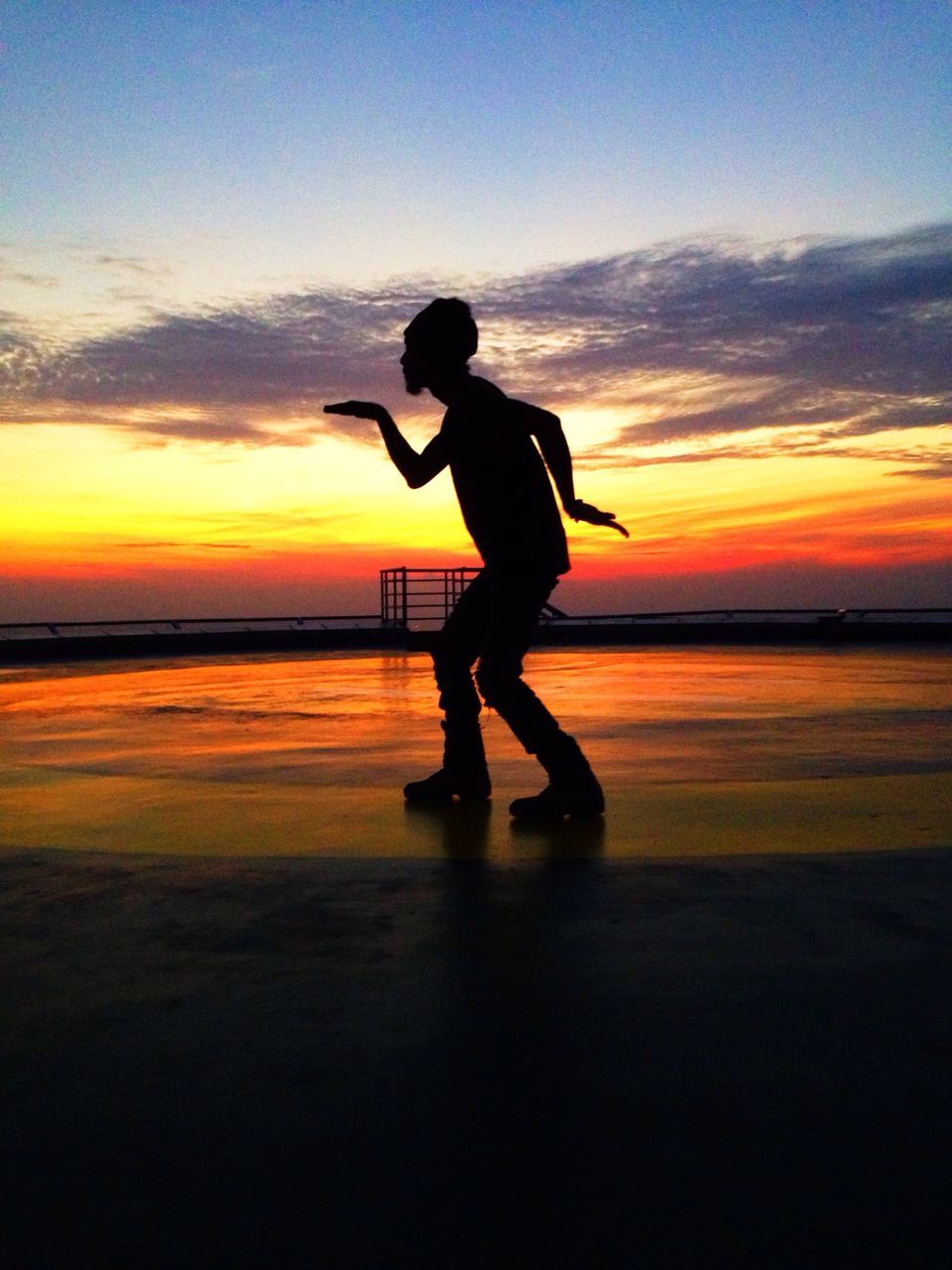 sunset, full length, sea, water, silhouette, sky, lifestyles, leisure activity, orange color, standing, horizon over water, beach, shore, scenics, tranquil scene, beauty in nature, tranquility, idyllic