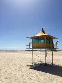 Built structure on beach against clear sky