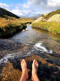 Low section of person by stream