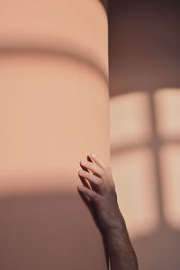 Close-up of woman hand on wall