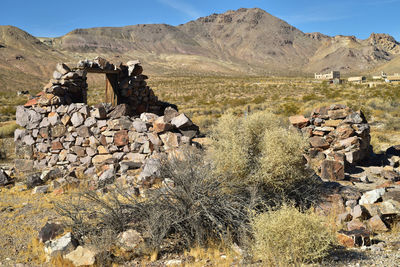 Stack of rocks on landscape against sky