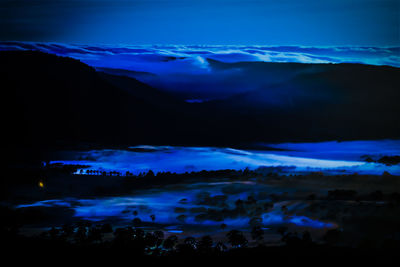 Scenic view of mountains against sky at night