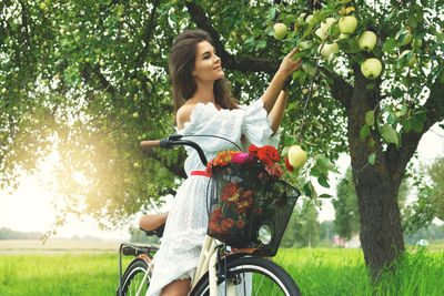 Side view of woman riding bicycle on field