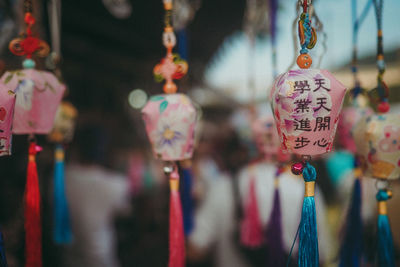 Close-up of decorations hanging for sale in market