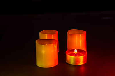 Close-up of lit candle against black background