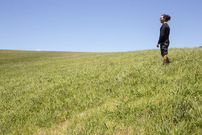 Full length of man on field against clear sky