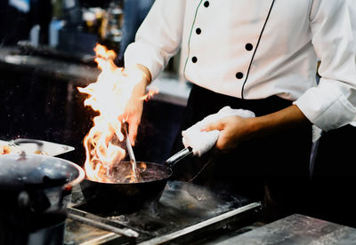 Midsection of man preparing food