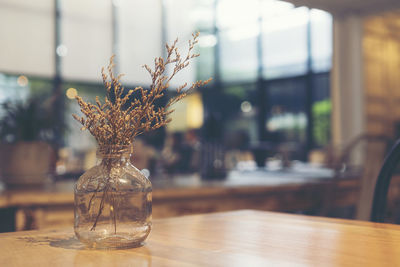 Flower vase on table in restaurant