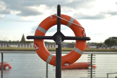 Close-up of red boat on river against sky