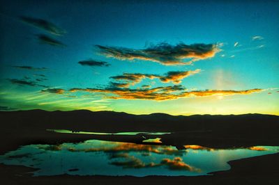 Scenic view of lake against sky at sunset