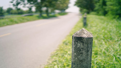 Close-up of wooden fence by road