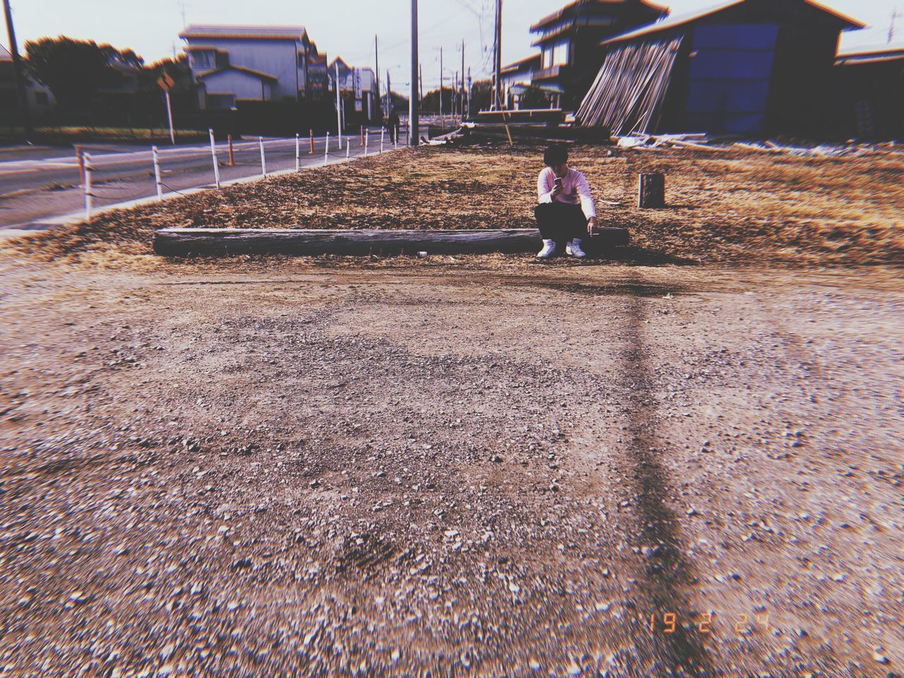 REAR VIEW OF BOY WALKING ON FOOTPATH IN CITY