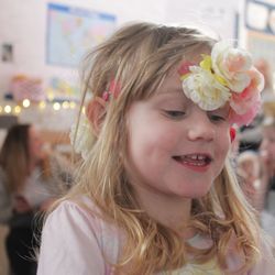 Close-up of smiling girl wearing flowers