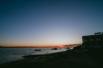 Scenic view of sea against clear sky during sunset