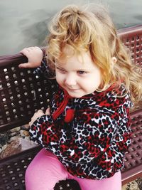 Portrait of cute girl sitting outdoors