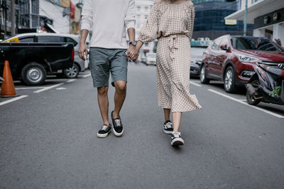 Low section of people walking on road