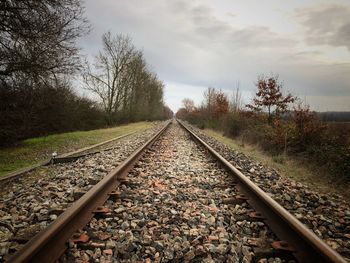 Surface level of railroad tracks against sky