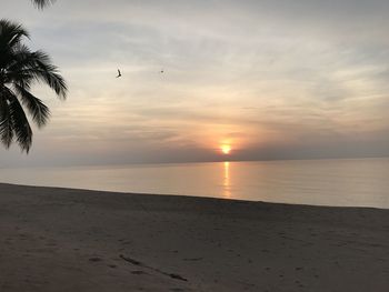 Scenic view of sea against sky at sunset