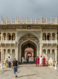 People walking in front of historical building