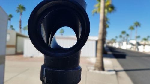 Close-up of coin-operated binoculars against sky