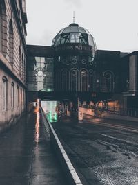 Street amidst buildings against sky in city