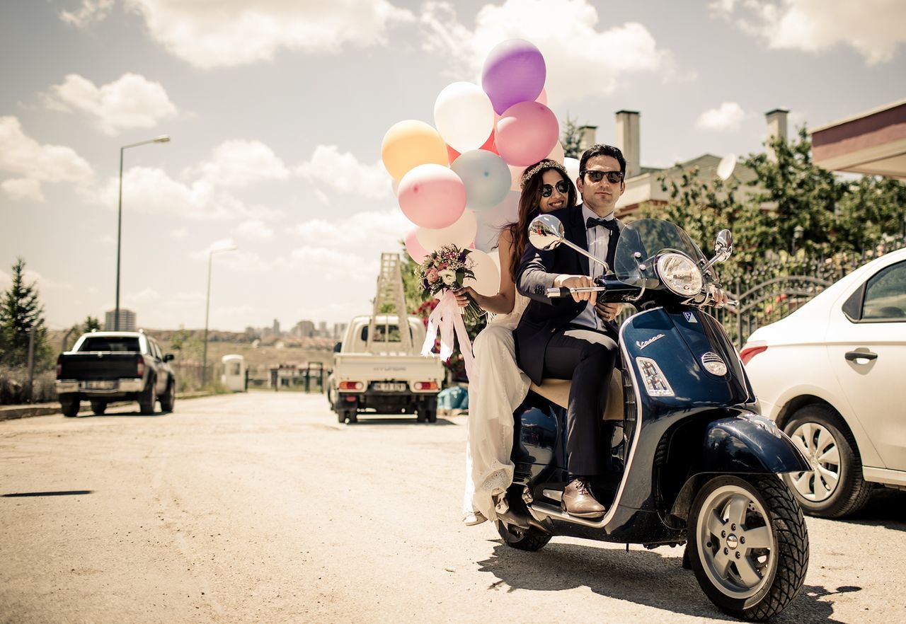 lifestyles, land vehicle, sky, leisure activity, transportation, car, full length, casual clothing, mode of transport, street, men, cloud - sky, rear view, road, sunlight, sitting, day, childhood