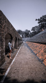 Man standing outside old building