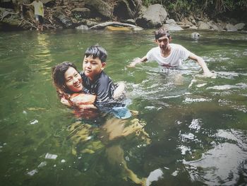 Portrait of smiling young couple in water