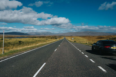 Road passing through landscape against sky