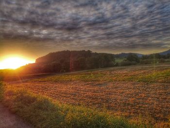 Scenic view of field against sky during sunset