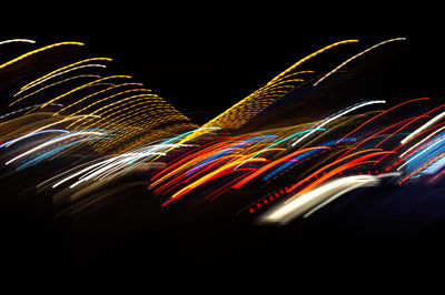 Low angle view of light trails at night