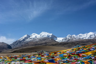 Prayer flags against snowcapped mountains