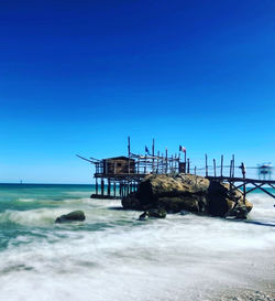 Scenic view of sea against clear blue sky